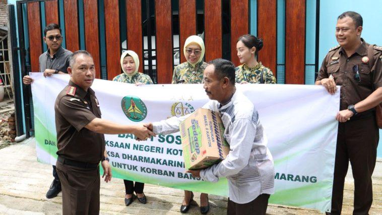 Kepala Kejari Kota Semarang Agung Mardiwibowo (kiri) menyerahkan secara bantuan secara simbolis untuk warga terdampak banjir. (istimewa)