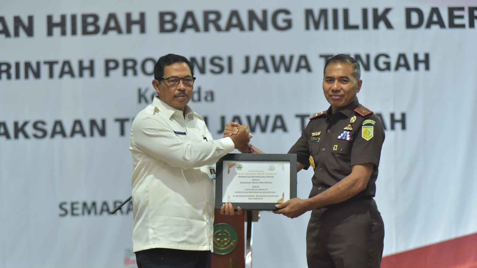 Pj Gubernur Jateng menyerahkan hibah tanah secara simbolis kepada Kajati Jateng. (istimewa)