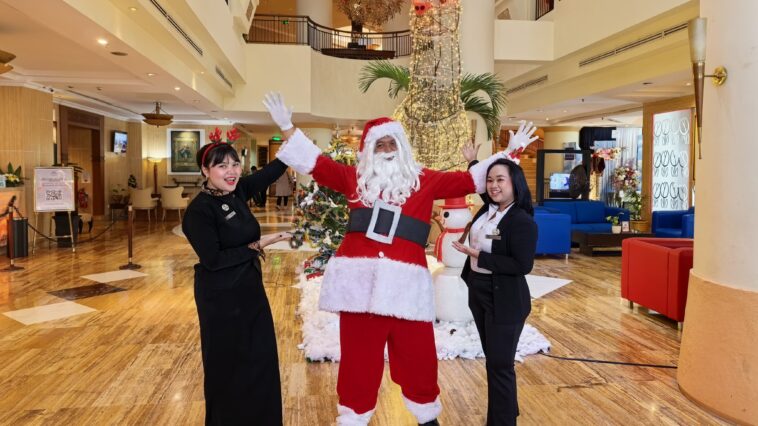 Staf Grand Candi Hotel dan 'Santa Clause' menyambut tamu jelang luburan akhir tahun. *istimewa